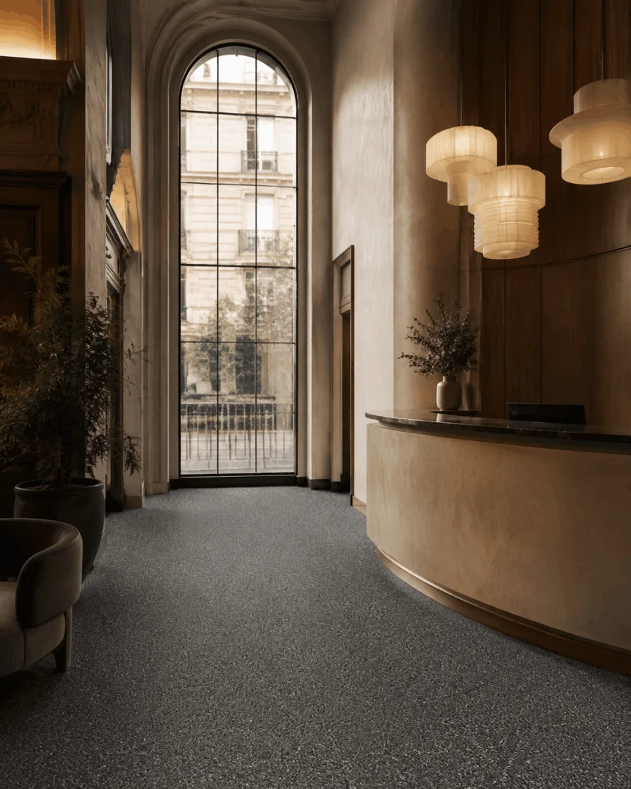 Dark aggregate stone carpet flooring in a hotel lobby